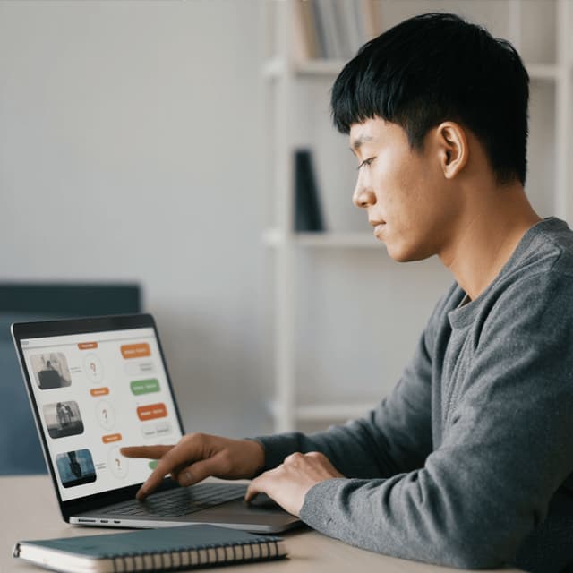 Min-jun Park sitting behind a laptop in an office